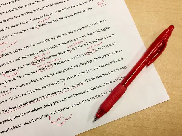 A picture of a printed page, which has been marked up with a red pen.